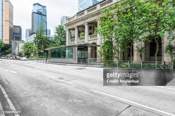 urban road through legislative council in central hong kong - hong kong legislative council stock pictures, royalty-free photos & images