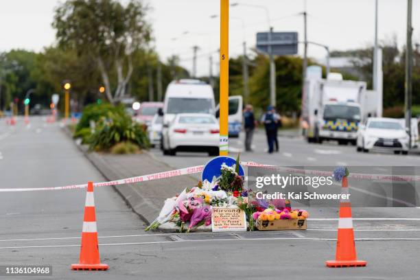 Flowers and condolences are seen on Linwood Avenue near Linwood mosque on March 16, 2019 in Christchurch, New Zealand. At least 49 people are...