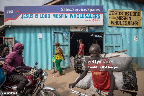 People seen passing by a wholesale place in Kakuma refugee camp, northwest Kenya.. Kakuma is home to members of the local Turkana community and the...