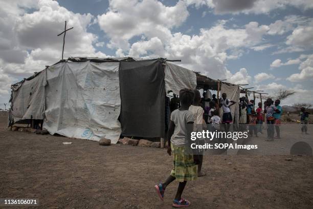 Children seen walking past a church in Kakuma refugee camp, northwest Kenya. Kakuma is home to members of the local Turkana community and the nearby...