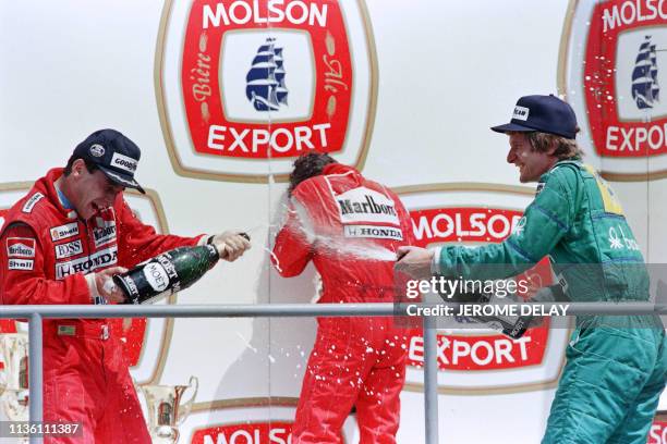 French driver Alain Prost is showered with Champagne by Ayrton Senna of Brazil and Thierry Boutsen of Belgium following the 1988 Canadian Grand Prix...