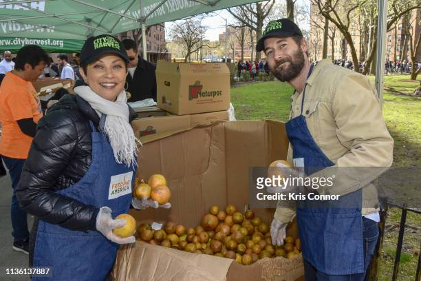 Nutritionist Ellie Krieger and actor Ryan Eggold volunteer with Feeding America And City Harvest to raise awareness for Earth Month handing out food...