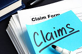 Stack of Claims applications on a desk.