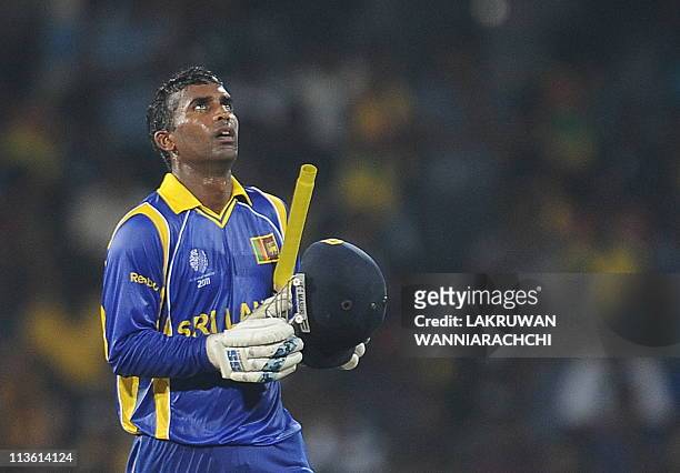 Sri Lankan cricketer Chamara Silva reacts after scoring a half-century during the Group A match in the World Cup Cricket tournament between Sri Lanka...