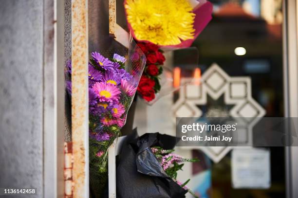 Flowers and cards are left outside the mosque at the Islamic Council of Victoria on March 16, 2019 in Melbourne, Australia. At least 49 people are...