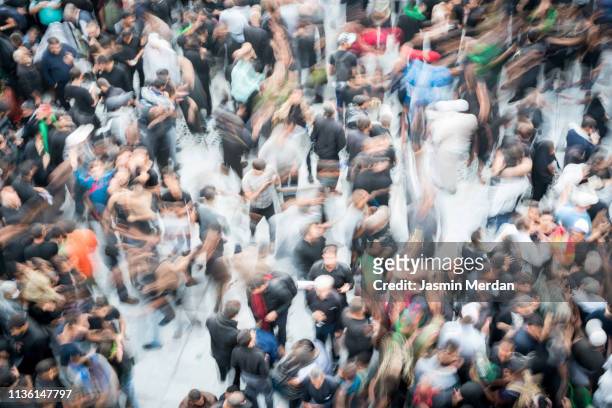crowded people motion on street - crowd of people from above stock pictures, royalty-free photos & images