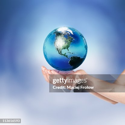 Hands with small floating earth globe Hands with small floating earth globe
