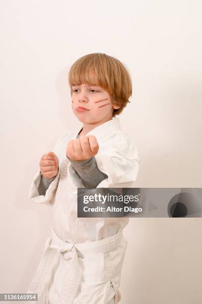 small child  with fists in defense position doing karate - child punching stock pictures, royalty-free photos & images