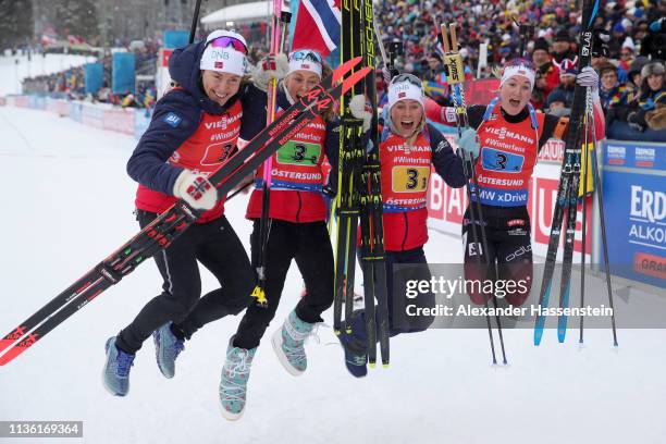 Synnoeve Solemdal, Ingrid Landmark Tandrevold, Tiril Eckhoff and Marte Olsbu Roeiseland of Norway celebrate after winning gold during the Women's...