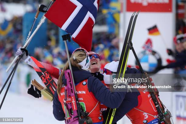 Synnoeve Solemdal, Ingrid Landmark Tandrevold and Marte Olsbu Roeiseland of Norway celebrate after winning gold during the Women's 4x6km Relay at the...