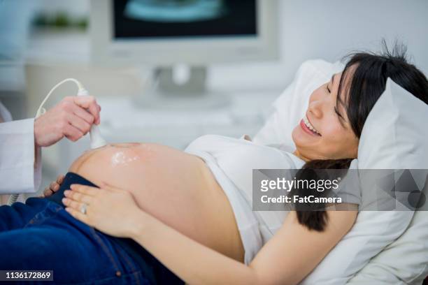 performing an ultrasound - prenatal care stock pictures, royalty-free photos & images