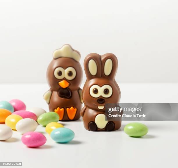 a variety of easter chocolates and candy on white background - easter chocolate stock pictures, royalty-free photos & images