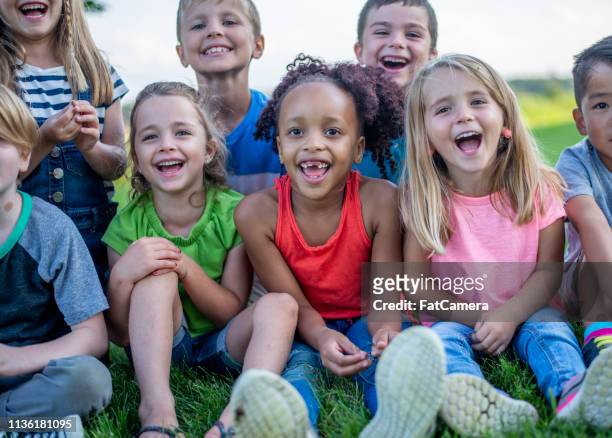 kindergarten kids in a park - summer camp kids stock pictures, royalty-free photos & images