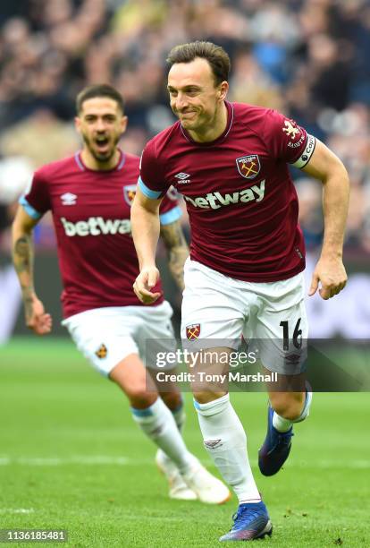 Mark Noble of West Ham United celebrates after scoring his team's first goal during the Premier League match between West Ham United and Huddersfield...