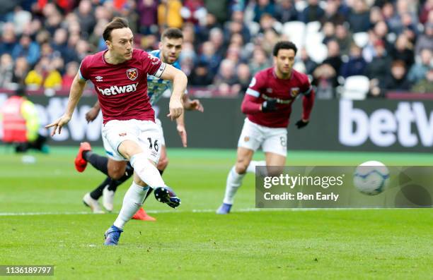Mark Noble of West Ham United scores their first goal from the penalty spot during the Premier League match between West Ham United and Huddersfield...