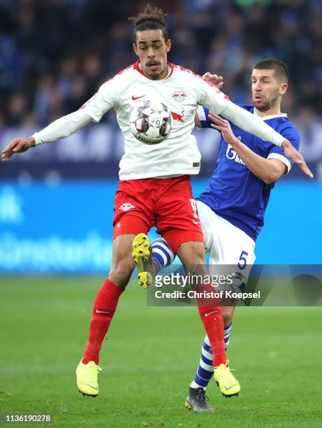 Yussuf Poulsen of RB Leipzig is challenged by Matija Nastasic of FC Schalke shoots during the Bundesliga match between FC Schalke 04 and RB Leipzig...