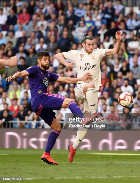Gareth Bale of Real Madrid is challenged by Nestor Araujo of Celta Vicelebrates victory during the La Liga match between Real Madrid CF and RC Celta...