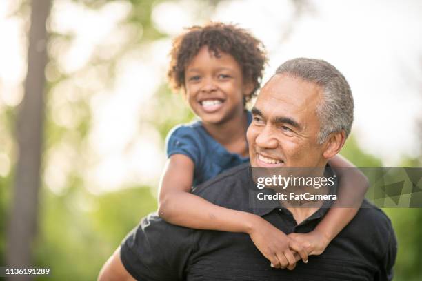 shoulder ride - granddaughter stock pictures, royalty-free photos & images