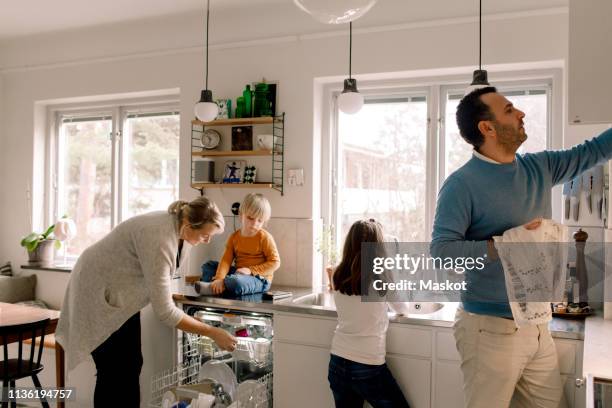 family working in kitchen at home - spring clean and female stock pictures, royalty-free photos & images