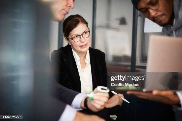 male entrepreneur giving presentation to bank managers during meeting in creative office - private equity stock pictures, royalty-free photos & images