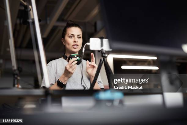 Female entrepreneur giving presentation on solar toy car through conference call in creative office