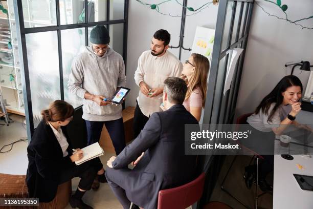 high angle view of entrepreneurs discussing on project with bank managers in creative office - venture capital stock-fotos und bilder