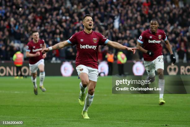 Javier Hernandez of West Ham United celebrates after scoring his team's fourth goal during the Premier League match between West Ham United and...