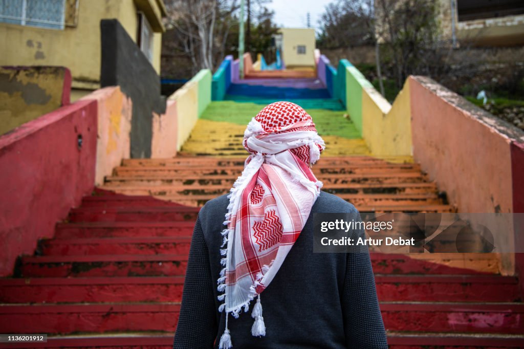 Bedouin guy with beautiful colorful stairs in the city of Amman.