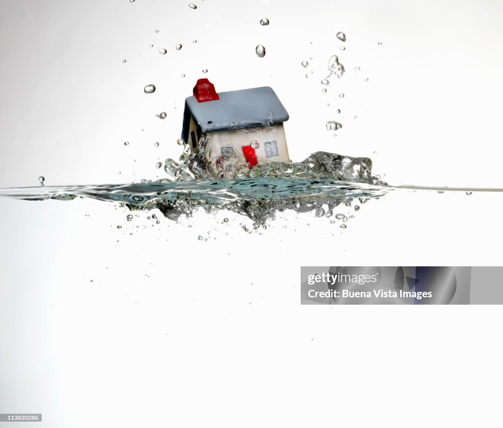 House sinking in water.