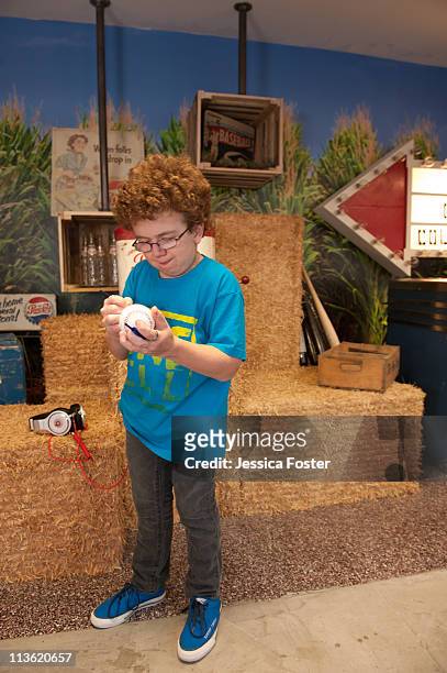 Keenan Cahill autographs a baseball during his visit to the MLB Fan Cave located on Broadway and 4th Street on Tuesday, May 3, 2011 in New York City.