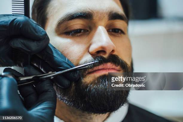 client visiting barber shop - hair stylist - mustache stock pictures, royalty-free photos & images