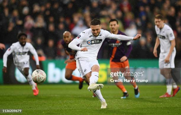 Matt Grimes of Swansea City scores his team's first goal from the penalty spot during the FA Cup Quarter Final match between Swansea City and...