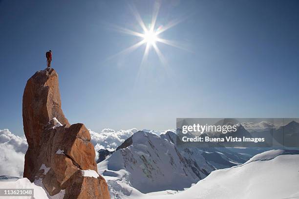 lone climber on top of a peak - summit stock pictures, royalty-free photos & images