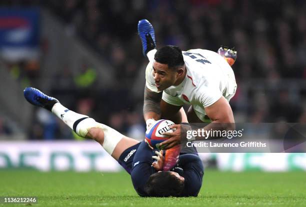 Manu Tuilagi of England is tackled by Byron McGuigan of Scotland during the Guinness Six Nations match between England and Scotland at Twickenham...