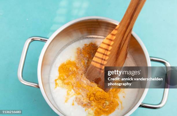 turmeric latte preparation - coconut milk stock pictures, royalty-free photos & images