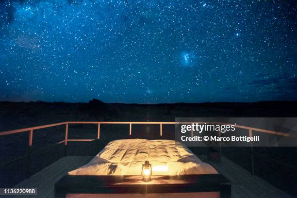 empty bed outdoor on a starry night - empty bedroom stock-fotos und bilder