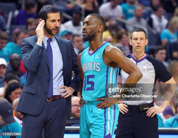 Charlotte Hornets head coach James Borrego, left, talks with guard Kemba Walker during first-half action against the Orlando Magic at Spectrum Center...