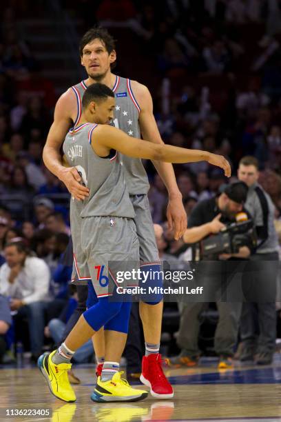 Boban Marjanovic of the Philadelphia 76ers hugs Zhaire Smith against the Chicago Bulls in the fourth quarter at the Wells Fargo Center on April 10,...