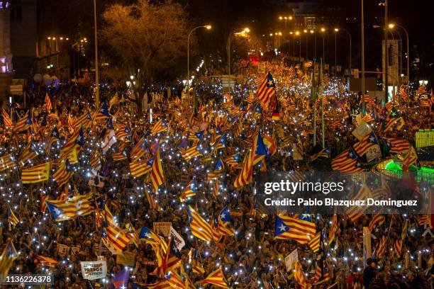 Protesters wave Catalan Independence flags during a demonstration titled 'Self-determination is not a crime' at Cibeles Square on March 16, 2019 in...