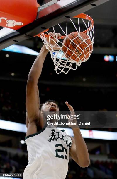 Xavier Tillman of the Michigan State Spartans dunks the ball in the second half against the Wisconsin Badgers during the semifinals of the Big Ten...