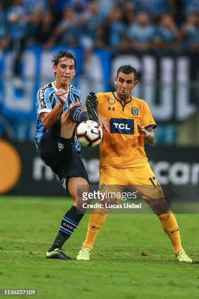 Pedro Geromel of Gremio battles for the ball against German Herrera of Rosario Central during the match between Gremio and Libertad, as part of Copa...