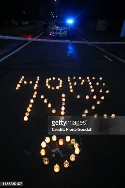 Candles at the memorial of flowers left on Deans Rd near the Al Noor mosque March 17, 2019 in Christchurch, New Zealand. 49 people are confirmed...