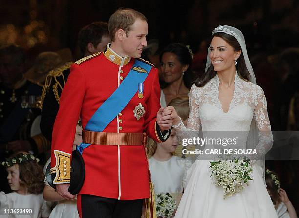 Britain's Prince William and his wife Kate, Duchess of Cambridge, look at each other as they come out of Westminster Abbey following their wedding...