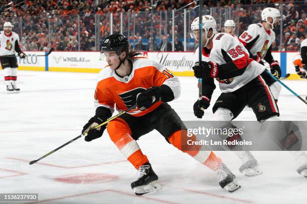 Nolan Patrick of the Philadelphia Flyers skates against Magnus Paajarvi of the Ottawa Senators on March 11, 2019 at the Wells Fargo Center in...