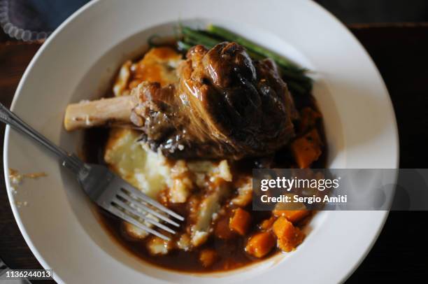 lamb shank with mash potatoes and carrots - lamb shank stock pictures, royalty-free photos & images