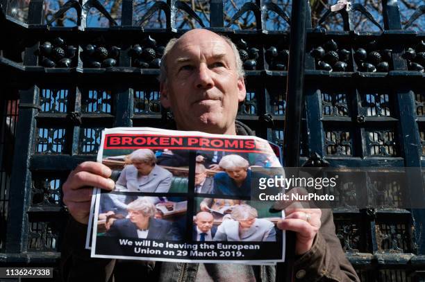 Pro-Brexit supporter holds a placard depicting Prime Minister Theresa May during a protest outside the Houses of Parliament on 10 April, 2019 in...