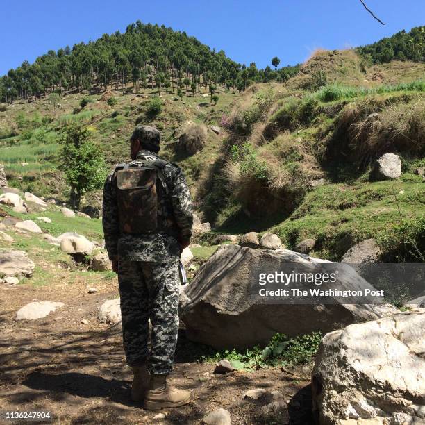 Pakistani soldier guards an area near the site where Indian jets tried to strike a suspected militant camp in February.
