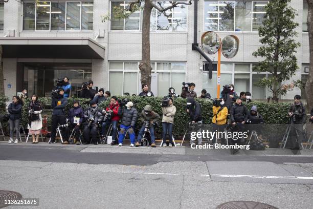 Members of the media gather outside the Tokyo District Court as the questioning of Carole Ghosn, wife of former Nissan Motor Co. Chairman Carlos...