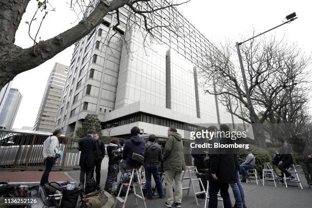 Members of the media gather outside the Tokyo District Court as the questioning of Carole Ghosn, wife of former Nissan Motor Co. Chairman Carlos...