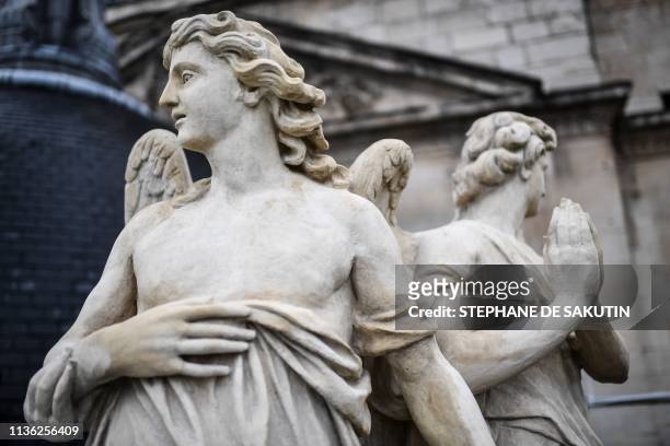 Restored angel sculptures are pictured after their re-installation on the dome of the Notre-Dame du Val-de-Grace church in central Paris on April 10,...